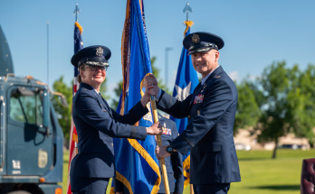 Maj. Gen. Stacy Huser, 20th Air Force commander, left, passes the guidon to Col. David Wyrick during the 341st Missile Wing change of command ceremony at Malmstrom Air Force Base, Montana, July 2, 2026. The ceremony marked the formal transfer of authority and responsibility for the wing, which operates and maintains intercontinental ballistic missiles in support of the nation's strategic deterrence mission. Photo credit Senior Airman Teniya Caldwell