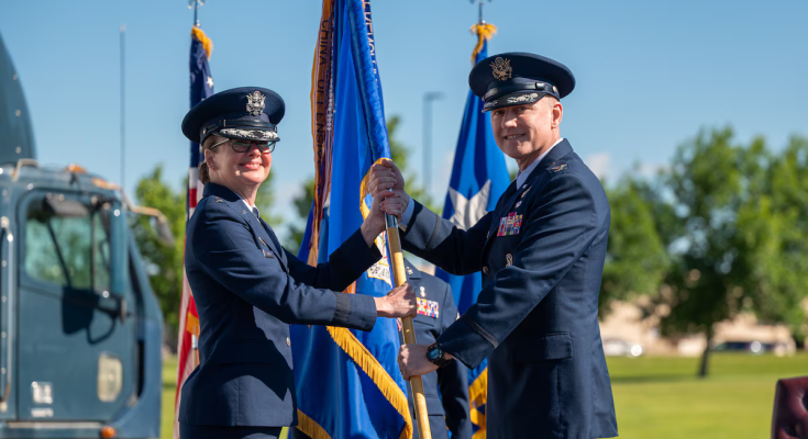 Maj. Gen. Stacy Huser, 20th Air Force commander, left, passes the guidon to Col. David Wyrick during the 341st Missile Wing change of command ceremony at Malmstrom Air Force Base, Montana, July 2, 2026. The ceremony marked the formal transfer of authority and responsibility for the wing, which operates and maintains intercontinental ballistic missiles in support of the nation's strategic deterrence mission. Photo credit Senior Airman Teniya Caldwell